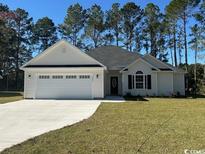 Newly constructed home with white siding, gray roof, and a 2-car garage at 3397 Dusty Rd., Loris, SC 29569