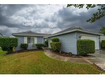 Charming single-story home with attached garage and manicured lawn at 213 Birkdale Ln., Myrtle Beach, SC 29588