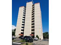 Ocean Villas building exterior, featuring multiple floors and ample parking at 7509 N Ocean Blvd., Myrtle Beach, SC 29572