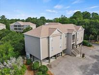 Multi-unit building with parking and surrounding trees at 194 South Cove Pl. # D, Pawleys Island, SC 29585
