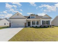 Two story craftsman style home with white siding and brick accents at 58 Millsite Ct., Georgetown, SC 29440