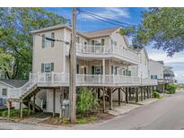 Two-story beach home with elevated deck and parking underneath at 6001-C21 S Kings Hwy., Myrtle Beach, SC 29575
