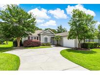 Single-story home with two-car garage and landscaping at 1575 Windsong Dr. Sw, Ocean Isle Beach, NC 28469