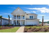 Two-story home with front porch and balcony at 7043 Shooting Star Way, Myrtle Beach, SC 29579