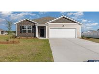 Exterior view of a charming one-story house with a two-car garage at 3865 Lady Bug Dr., Shallotte, NC 28470