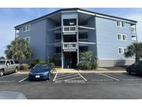 Three-story building with parking and balconies at 9540 Shore Dr. # 1-J, Myrtle Beach, SC 29572