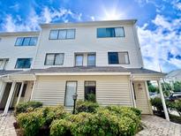 Two story light beige townhome with landscaping at 209 75Th Ave. N # 10, Myrtle Beach, SC 29572