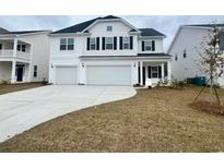 Two-story house with white siding, a two-car garage, and a neat lawn at 756 Enchantment Loop, Myrtle Beach, SC 29588