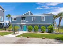 Two-story home with teal door and ocean view at 1919 South Waccamaw Dr., Garden City Beach, SC 29576
