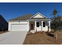 Cream-colored house with a gray roof, white garage door, and landscaping at 178 Calm Dr., Little River, SC 29566