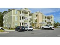 Two-story building with light green exterior and ample parking at 81 Delray Dr. # 2-A, Murrells Inlet, SC 29576