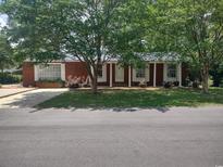 Brick ranch home with a covered porch, landscaping, and driveway at 105 Brown St., Tabor City, NC 28463