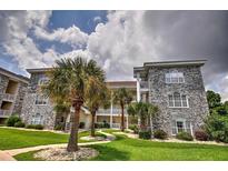 Exterior view of building with landscaping at 4709 Wild Iris Dr. # 104, Myrtle Beach, SC 29577