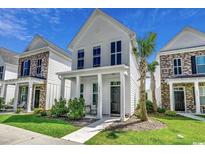 Two-story white house with gray front door and small front porch at 3507 Fountain Ln., Myrtle Beach, SC 29577