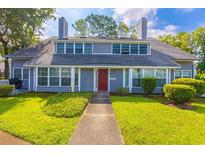 Charming two-story home with a red front door and a well-manicured lawn at 1203 Erin Way # B, Myrtle Beach, SC 29577