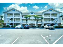Three-story building with balconies and ample parking at 5801 Oyster Catcher Dr. # 434, North Myrtle Beach, SC 29582