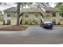 Condo building exterior view, showing parking and landscaping at 4450 Little River Inn Ln. # 608, Little River, SC 29566