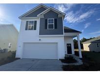 Two-story house with gray and white siding, a two-car garage, and landscaping at 549 Black Pearl Way, Myrtle Beach, SC 29588