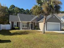 Tan house with gray roof, two-car garage, and palm tree in the front at 2549 Sugar Creek Ct., Myrtle Beach, SC 29579