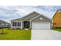 Gray house with white garage door and landscaping at 1028 Barrington Way, Conway, SC 29526