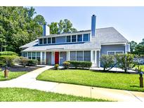 Gray house with red door and manicured landscaping at 1202 Tiffany Ln. # G, Myrtle Beach, SC 29577