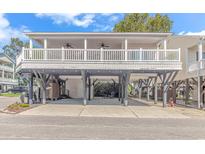 Elevated home with two-story deck and parking underneath at 6001-1889 S Kings Hwy., Myrtle Beach, SC 29575