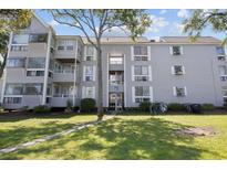 Three-story building with grey siding, balconies, and ample green space at 351 Lake Arrowhead Rd. # 11-342, Myrtle Beach, SC 29572