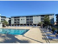 Community pool with lounge chairs, providing a relaxing outdoor space at 6000 N Ocean Blvd. # 242, North Myrtle Beach, SC 29582