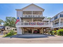 Two-story home with spacious deck and covered parking at 6001 S Kings Hwy., Myrtle Beach, SC 29575