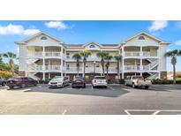 Three-story building exterior with parking in front at 5801 Oyster Catcher Dr. # 432, North Myrtle Beach, SC 29582