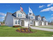 Row of new townhouses with attached garages and landscaping at 115 Talladega Dr. # 405, Myrtle Beach, SC 29579