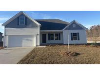 Two-story house with gray and white siding, a two-car garage, and a small front yard at 2323 King Farm Rd., Aynor, SC 29511