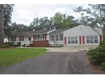 White ranch home with red accents and a double garage at 1726 Rice St., Georgetown, SC 29440