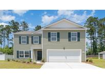 Two-story house with green siding and a two-car garage at 322 Acosta Circle, Conway, SC 29527