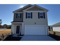 Two-story house with neutral siding and a two-car garage at 334 Cheerful Way, Little River, SC 29566