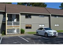 Exterior view of a condo building with parking and landscaping at 2000 Greens Blvd. # 18-D, Myrtle Beach, SC 29577