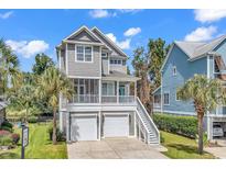 Two-story home with gray siding, two-car garage, and front porch at 6 Cottage Dr., Murrells Inlet, SC 29576