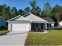 Newly constructed light gray house with a white garage door at Tbd 4 Casey Dr., Nichols, SC 29581