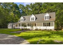 Two story home with wrap around porch and detached garage at 3758 Loblolly Ave., Little River, SC 29566