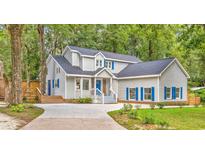 Two-story home with blue shutters and landscaped yard at 466 Bannockburn Dr., Pawleys Island, SC 29585