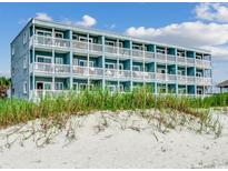 Multi-story building directly on the beach with multiple balconies at 116 South Waccamaw Dr. # 204, Garden City Beach, SC 29576