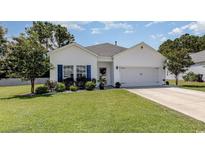 Charming one-story home with white siding and blue shutters at 339 Grove Park Loop, Murrells Inlet, SC 29576