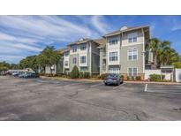Exterior view of a multi-unit building with parking at 127 Garden City Connector # 210, Murrells Inlet, SC 29576