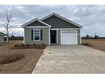 Newly constructed home with gray siding, white garage door, and landscaping at 824 Buttonwood Dr., Conway, SC 29527