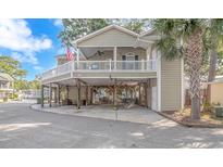 Elevated home with a large deck and parking underneath at 6001 - 7026 S Kings Hwy., Myrtle Beach, SC 29575