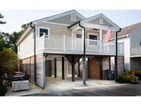 Two story home with a front deck and detached garage at 1517 Schooner Ct., Garden City Beach, SC 29576