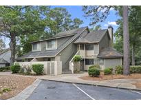 Attractive two-story condo with a gray exterior, landscaping, and parking at 110 Hartland Dr. # 15-E, Myrtle Beach, SC 29572