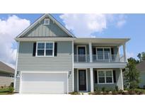 Two-story home with gray siding, white trim, and a front porch at 1833 Brook Park Pl., Conway, SC 29526