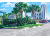 Oceanfront building with lush landscaping and parking at 10100 Beach Club Dr. # 14A, Myrtle Beach, SC 29572