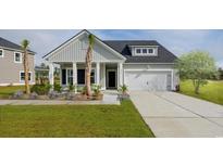 One-story home with gray siding, white trim, two-car garage, and palm trees at 5050 Selene Ct., Myrtle Beach, SC 29588